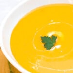 Instant Pot Butternut Squash soup in white bowl with parsley and nutmeg garnish