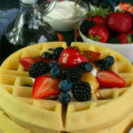 2 stacked gluten free waffles topped with fruit