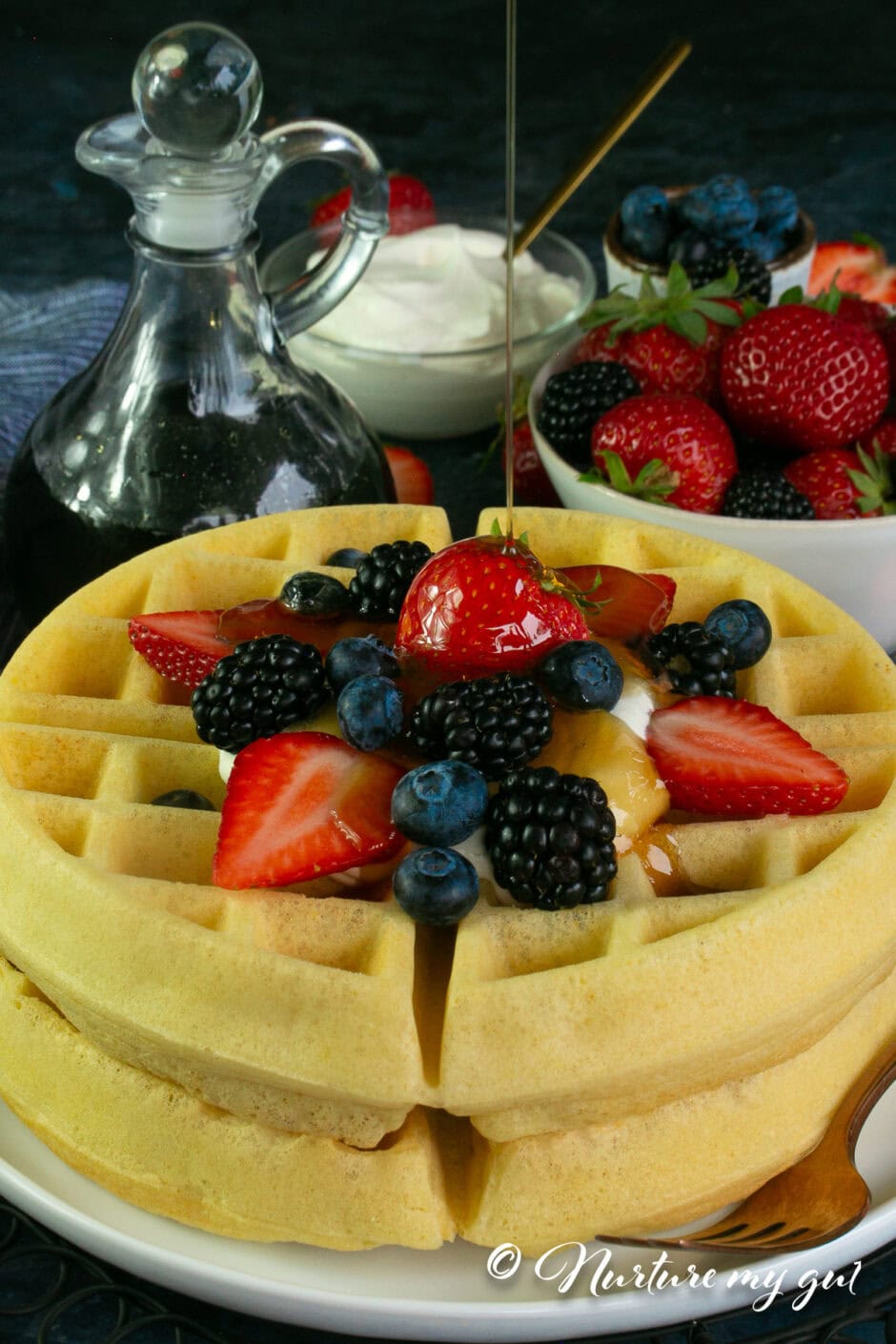 2 stacked gluten free waffles topped with fruit