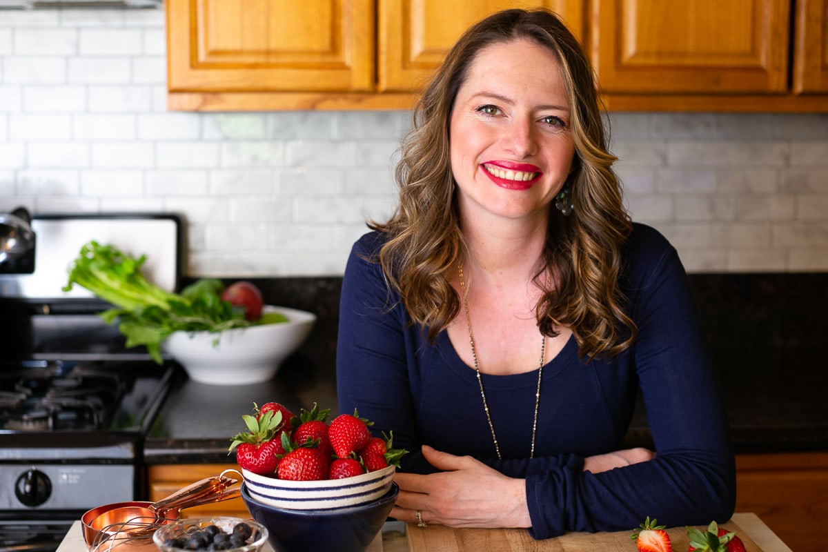 Ester Perez in kitchen with strawberries in bowl