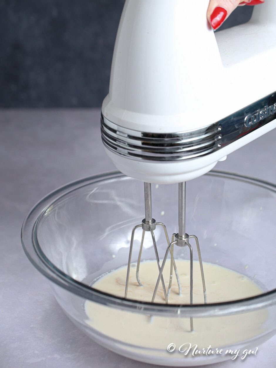 hand mixer in bowl to beat cream